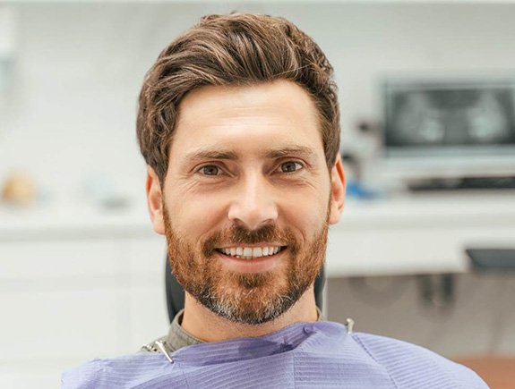 Close-up of a bearded male dental patient smiling