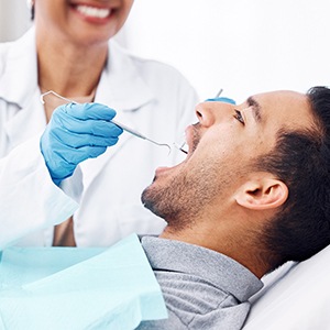 Man in gray shirt having dental exam