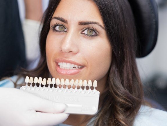 Woman trying on dental veneers from her cosmetic dentist in West Caldwell