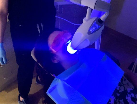 Woman receiving professional teeth whitening in West Caldwell from her cosmetic dentist
