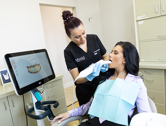 Woman getting digital dental impressions of her mouth taken