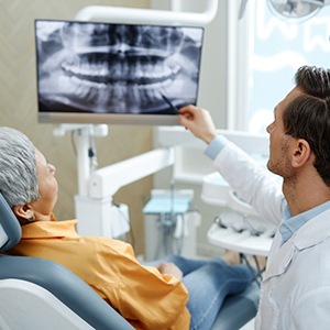 Dentist pointing to a dental x-ray