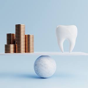 Tooth being balanced against coins