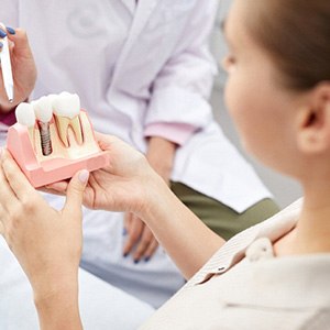 dentist explaining dental implant to patient