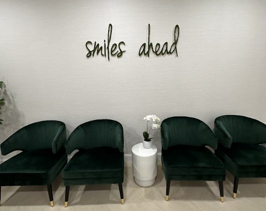 Black armchairs in dental office waiting room