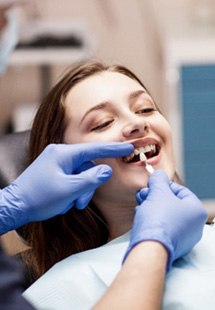 woman smiling while visiting dentist