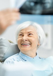 patient smiling while visiting dentist