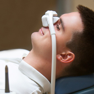 Patient relaxing while breathing in nitrous oxide in treatment chair