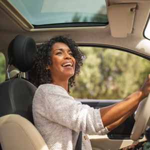 Woman smiling while driving