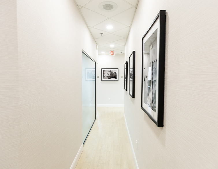 Dental office hallway with several large framed photos on the wall