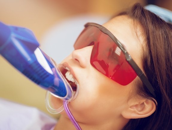 Girl receiving fluoride treatment in dental office