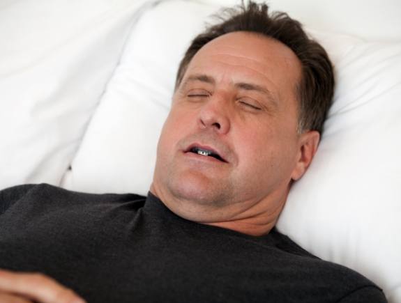 Sleeping man wearing an oral appliance