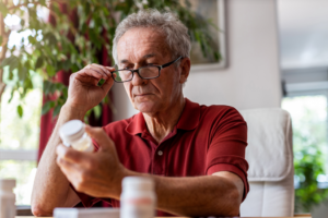 a patient reading a pill bottle label