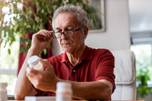 a patient reading a pill bottle label 