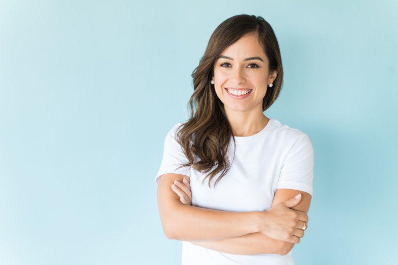 A woman smiling with her new dental implants